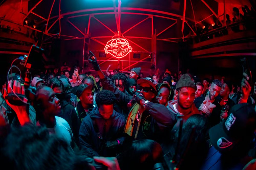 Resurgence FM neon sign above a live crowd